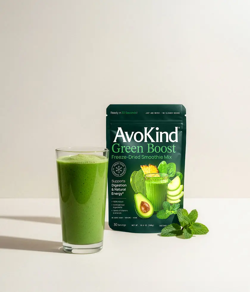 Green Boost pouch next to a glass of green smoothie and a few mint leaves